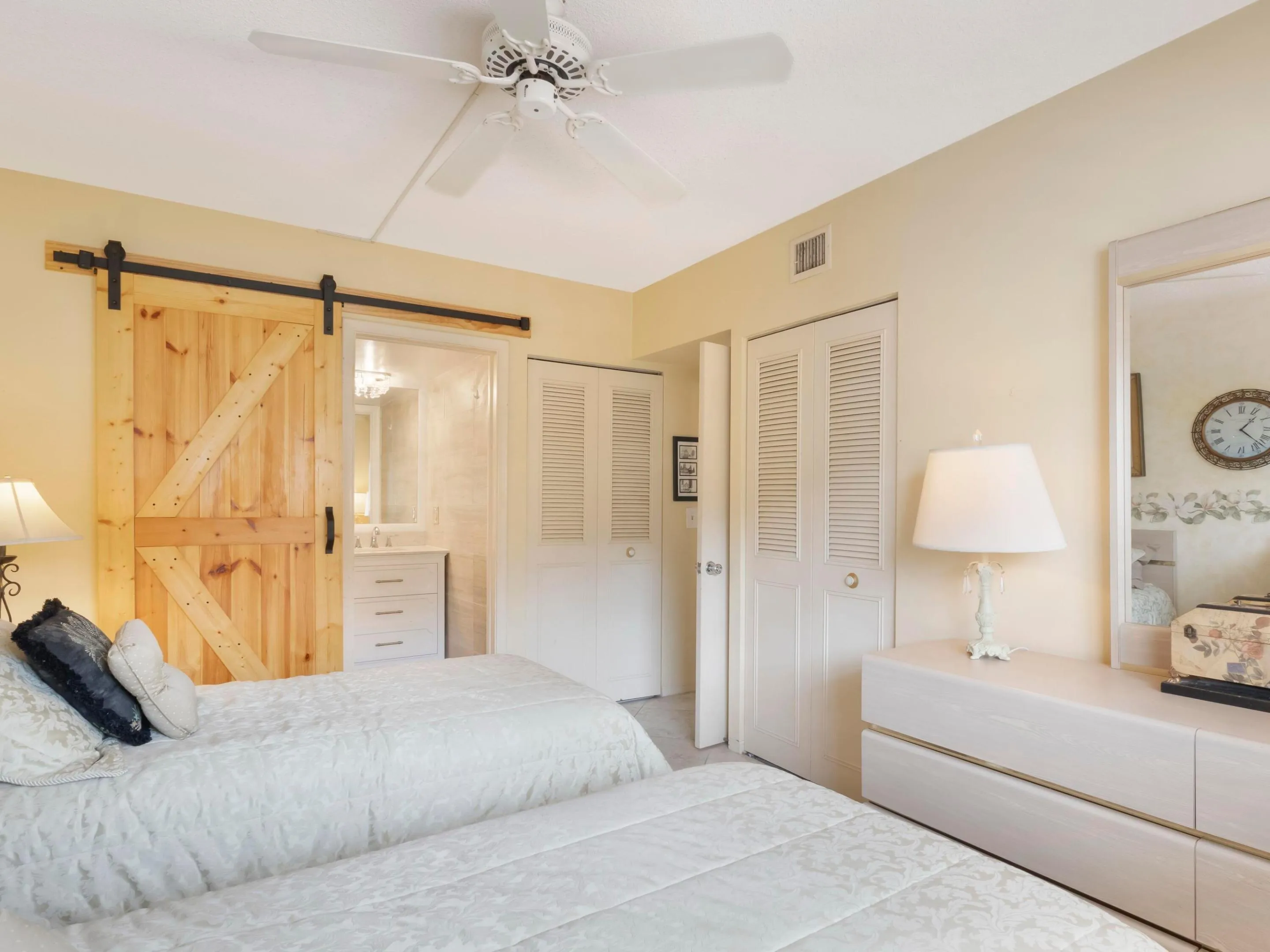 Spacious guest bedroom with dual closets and en suite bahroom