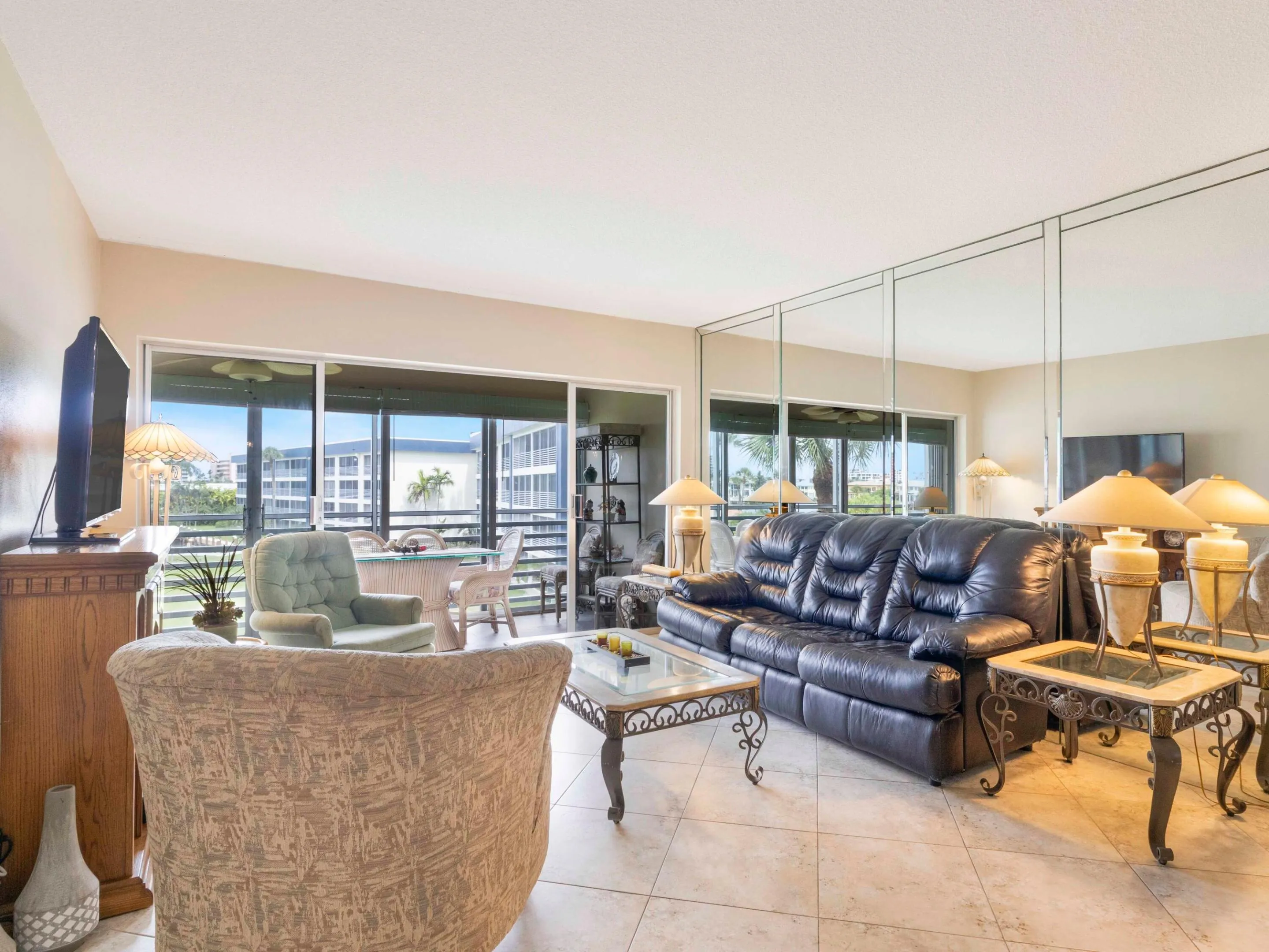 Living area opens to screened balcony with serene water views while enjoying the coastal breeze