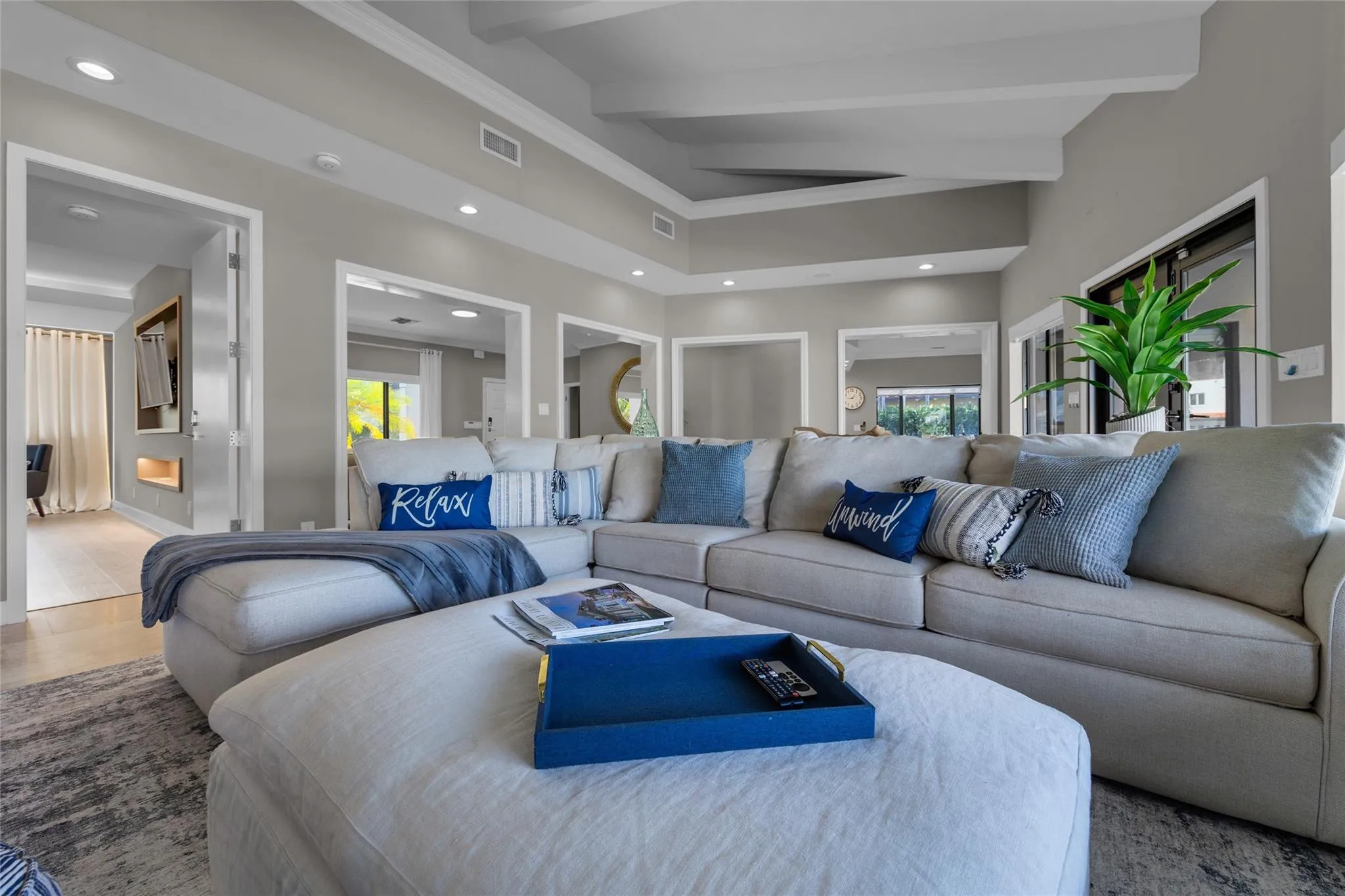 Open floor family room with large windows and patio access