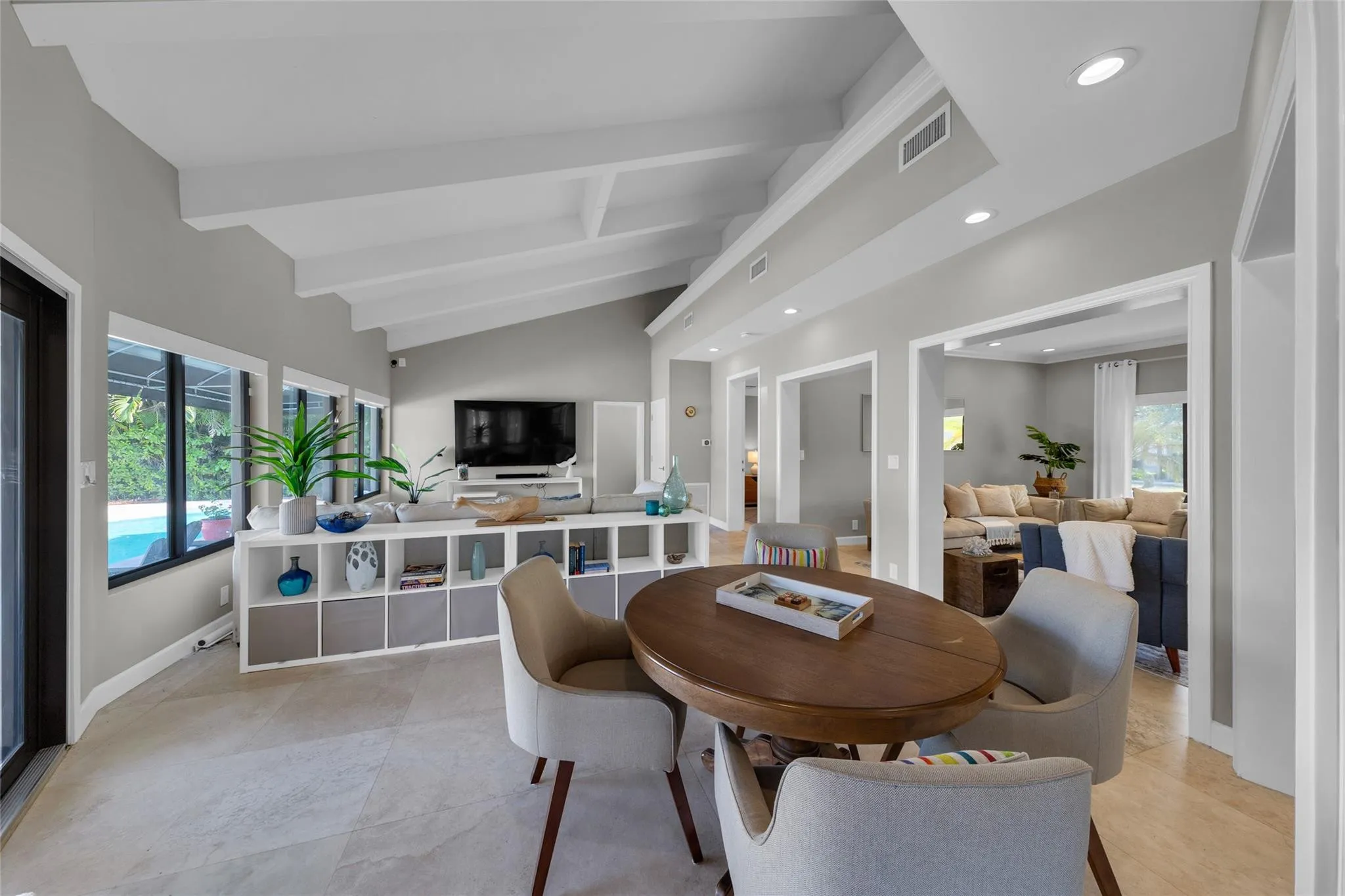 Open floor family room with large windows and patio access