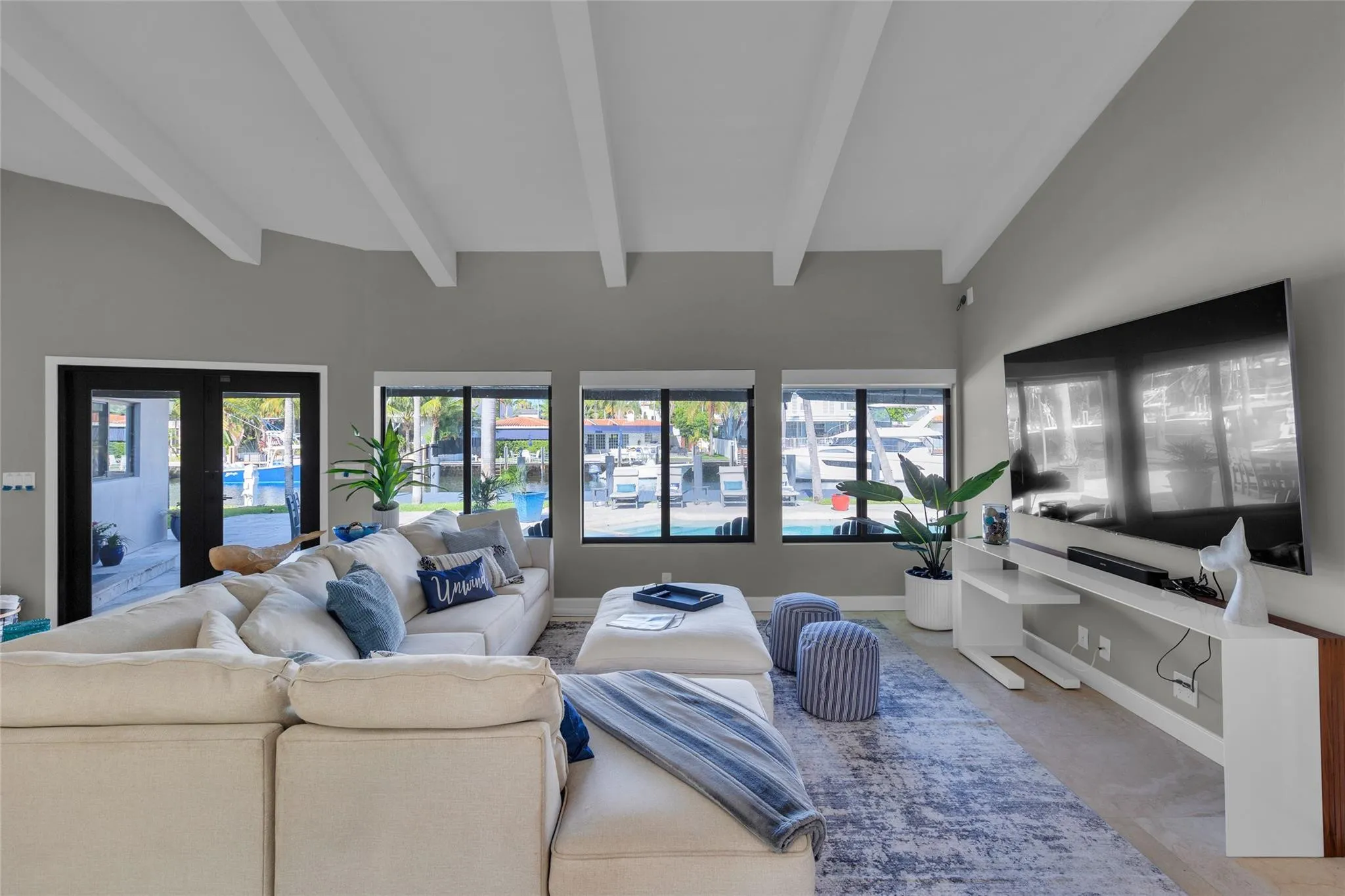 Open floor family room with large windows and patio access