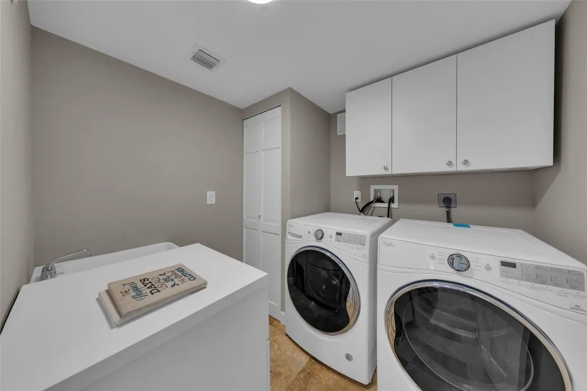 Laundry room with sink and storage