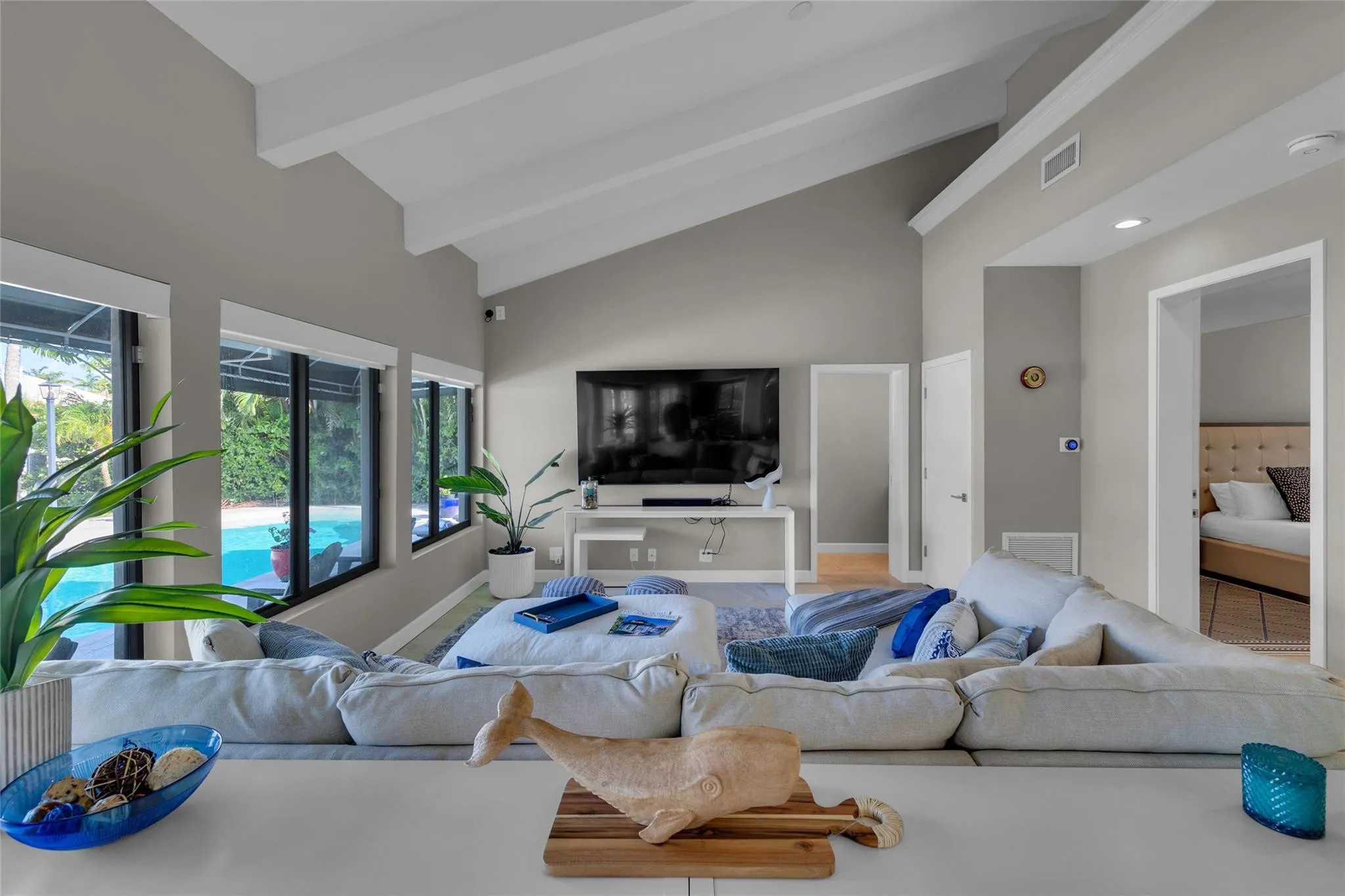 Open floor family room with large windows and patio access