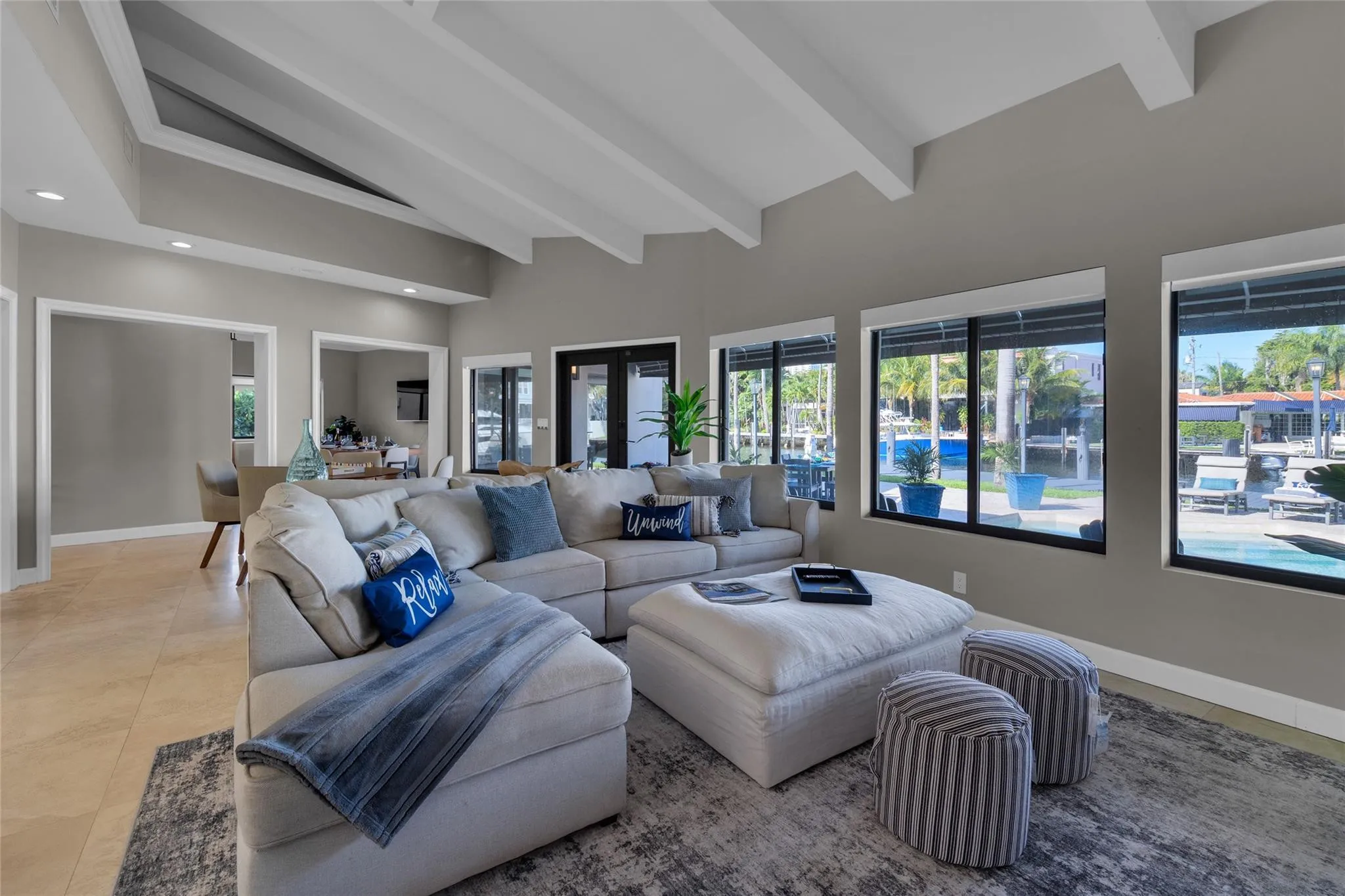 Open floor family room with large windows and patio access
