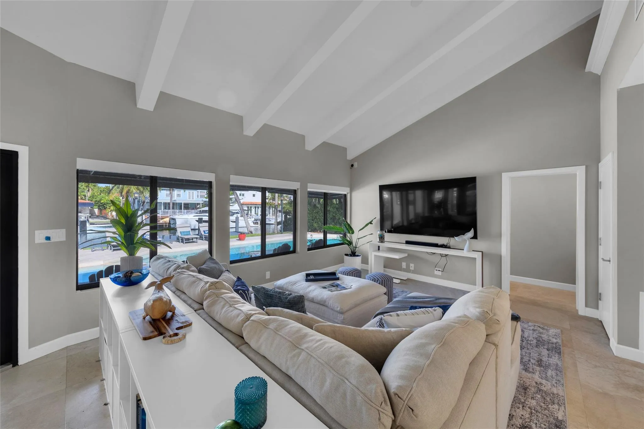 Open floor family room with large windows and patio access