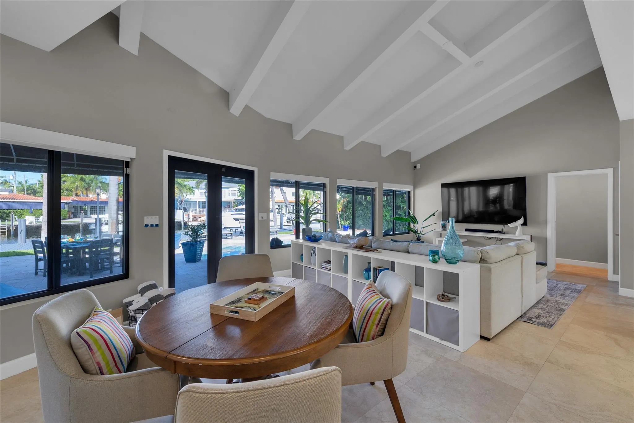 Open floor family room with large windows and patio access