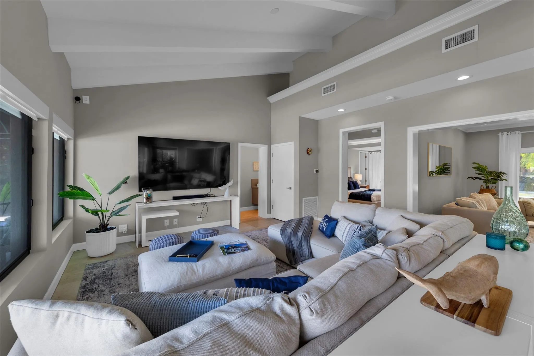 Open floor family room with large windows and patio access