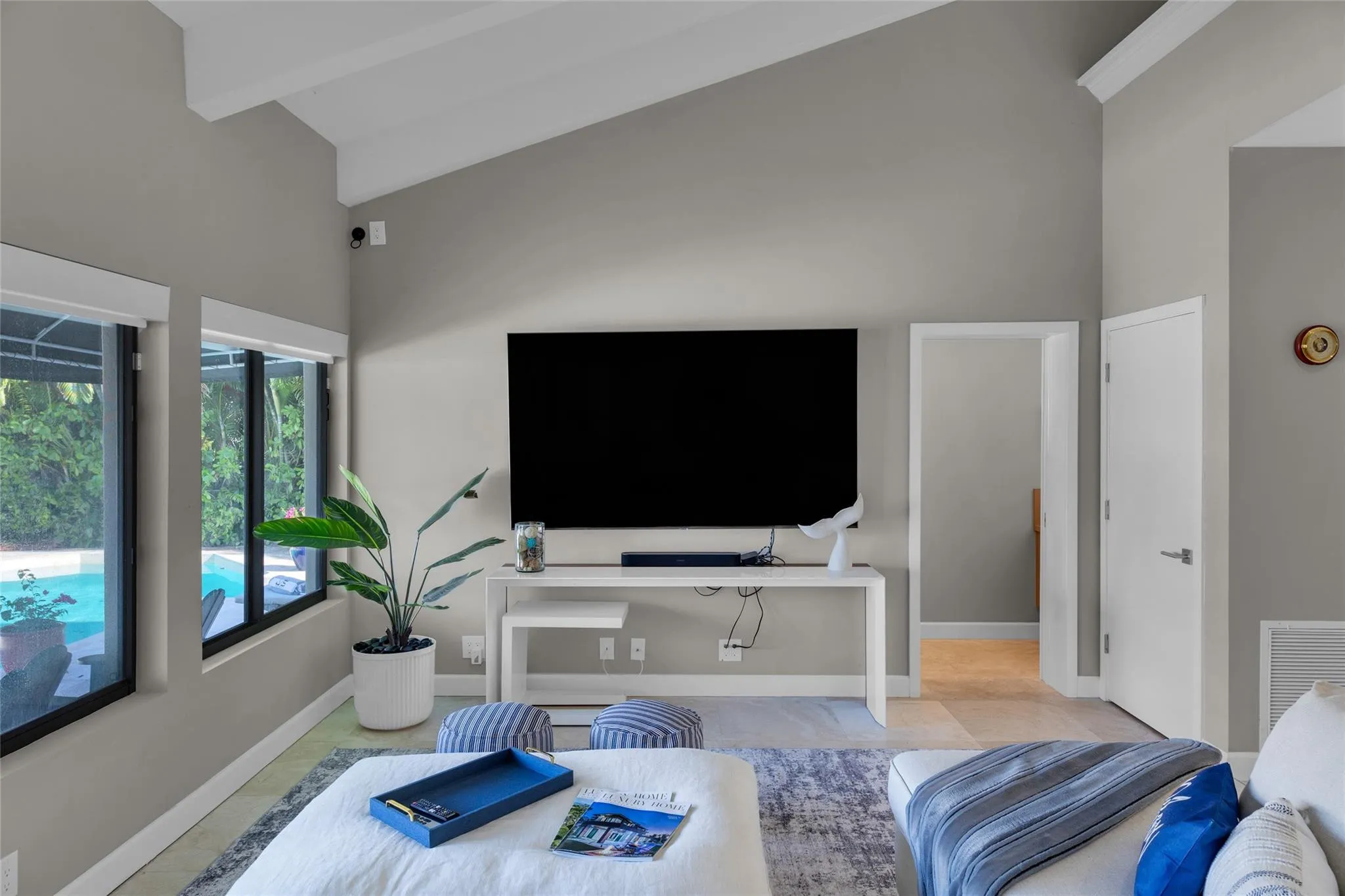 Open floor family room with large windows and patio access