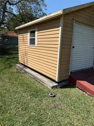 Side of storage shed with window.