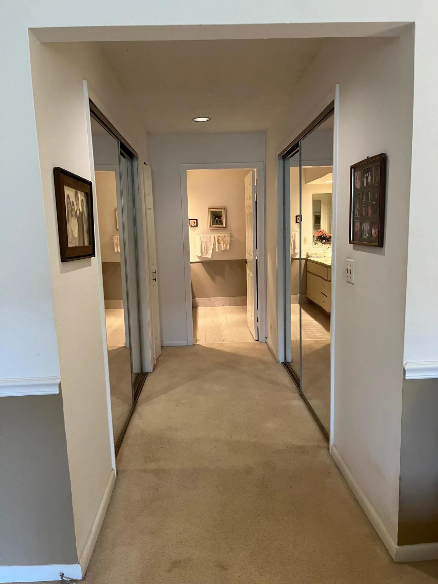 Two large walk-in closets with glass doors, leading towards master bathroom