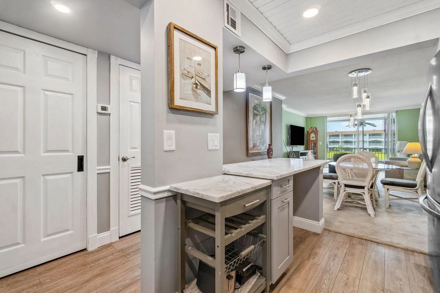Updated and open kitchen boasts shaker style cabinets, quartz countertops and stainless steel appliances