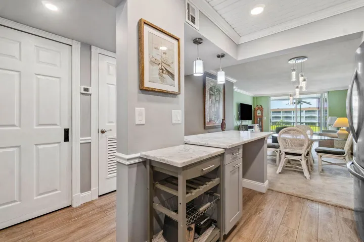 Updated and open kitchen boasts shaker style cabinets, quartz countertops and stainless steel appliances