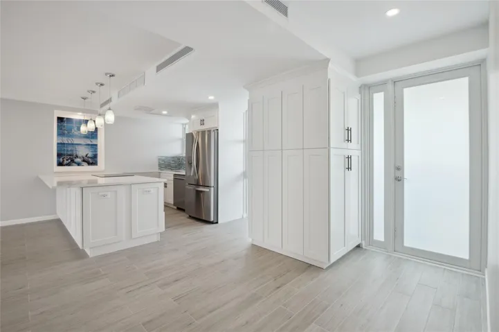 Vast quartz kitchen island, complemented by all-new soft-close cabinets, drawers, top-quality appliances and gorgeous views of the ocean and Lake Mayan.