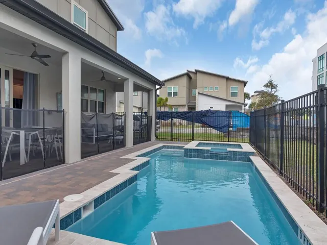 Heated Inground Pool with Jacuzzi, Paver Deck and Fenced with Safety Gate.
