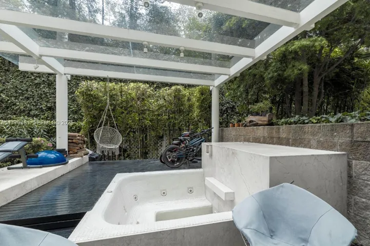 Soak year-round in your private, covered Jacuzzi, tucked away in your lush green oasis.