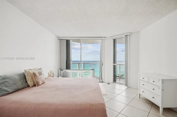 Spacious Primary Bedroom w/ Walk in Closets and Entrance to Balcomy for Ocean & City Views.