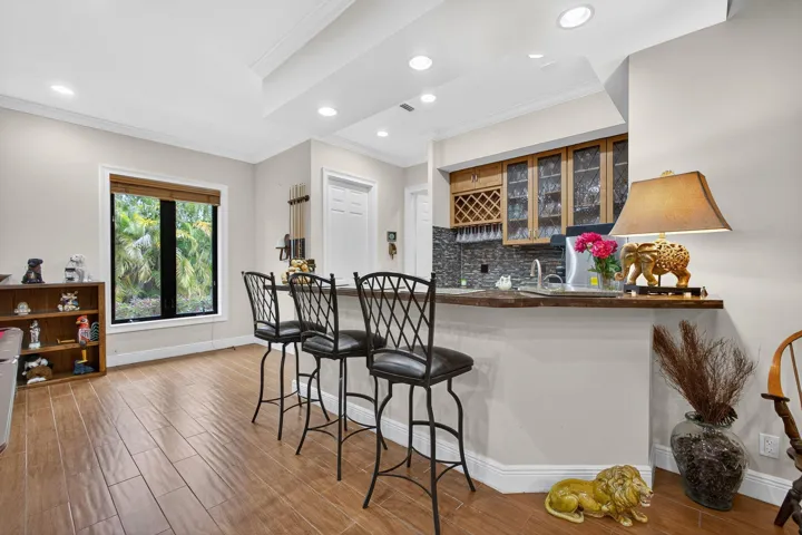 WET BAR WITH SINK AND SMALL REFRIGERATOR AND WINE REFRIG.