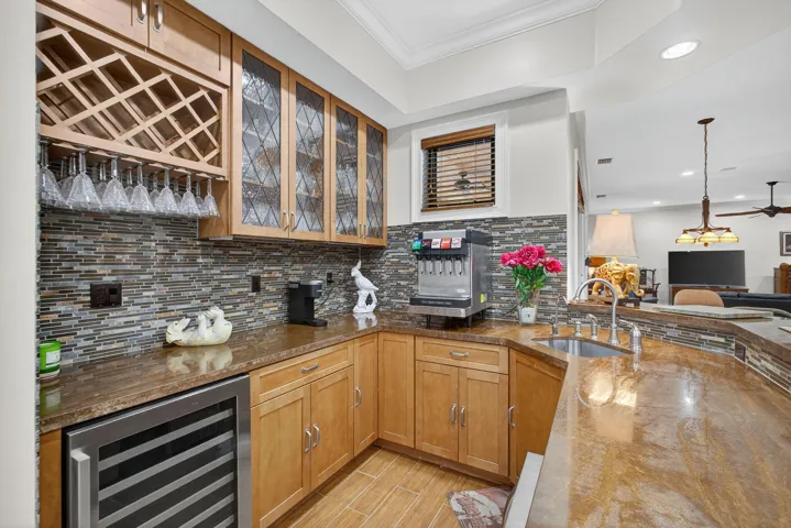 WET BAR WITH SINK AND SMALL REFRIGERATOR AND WINE REFRIG.
