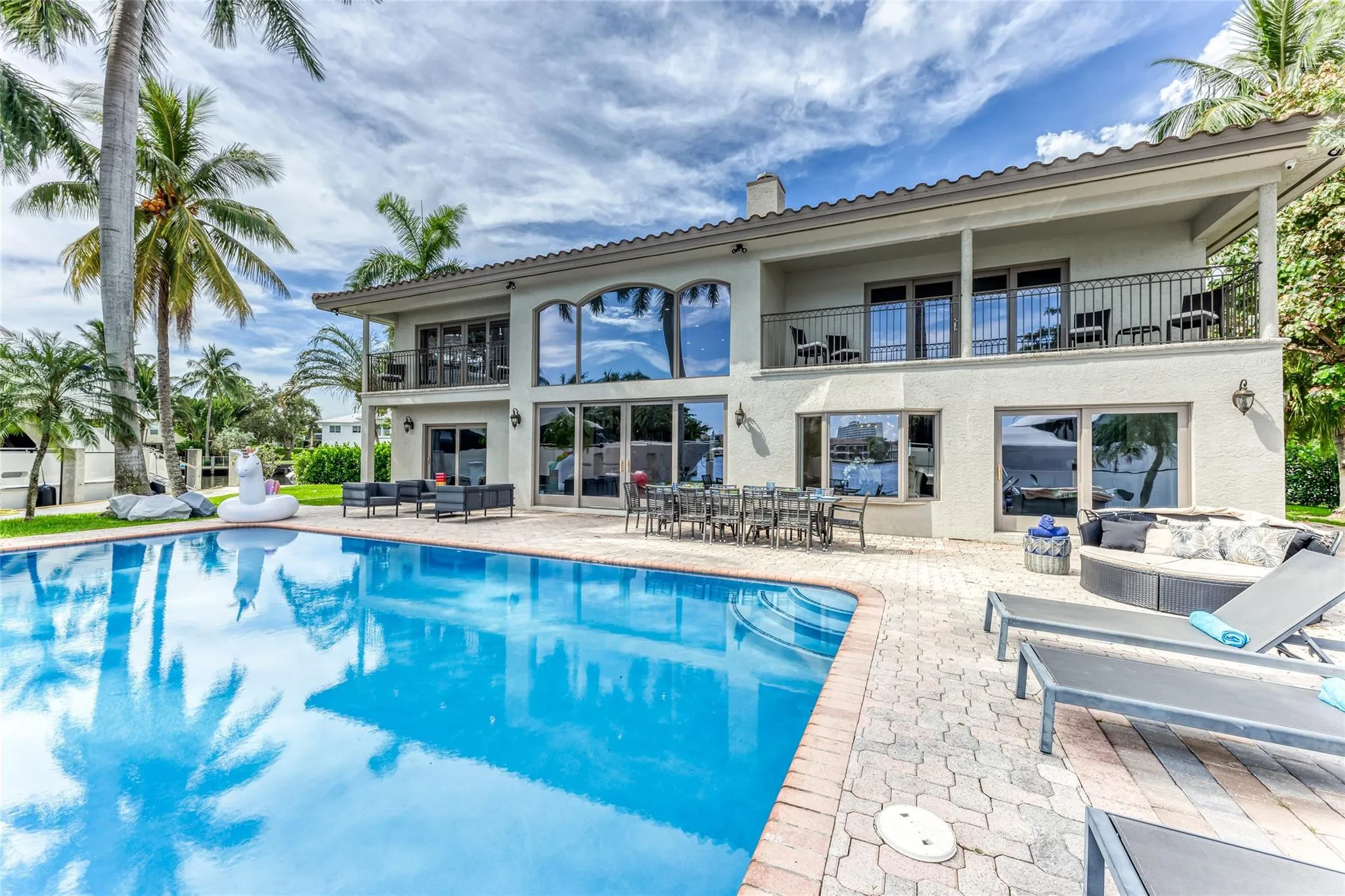 Outdoor waterfront Point Lot with pool area with outdoor dining, lounge chairs, BBQ & siting area.