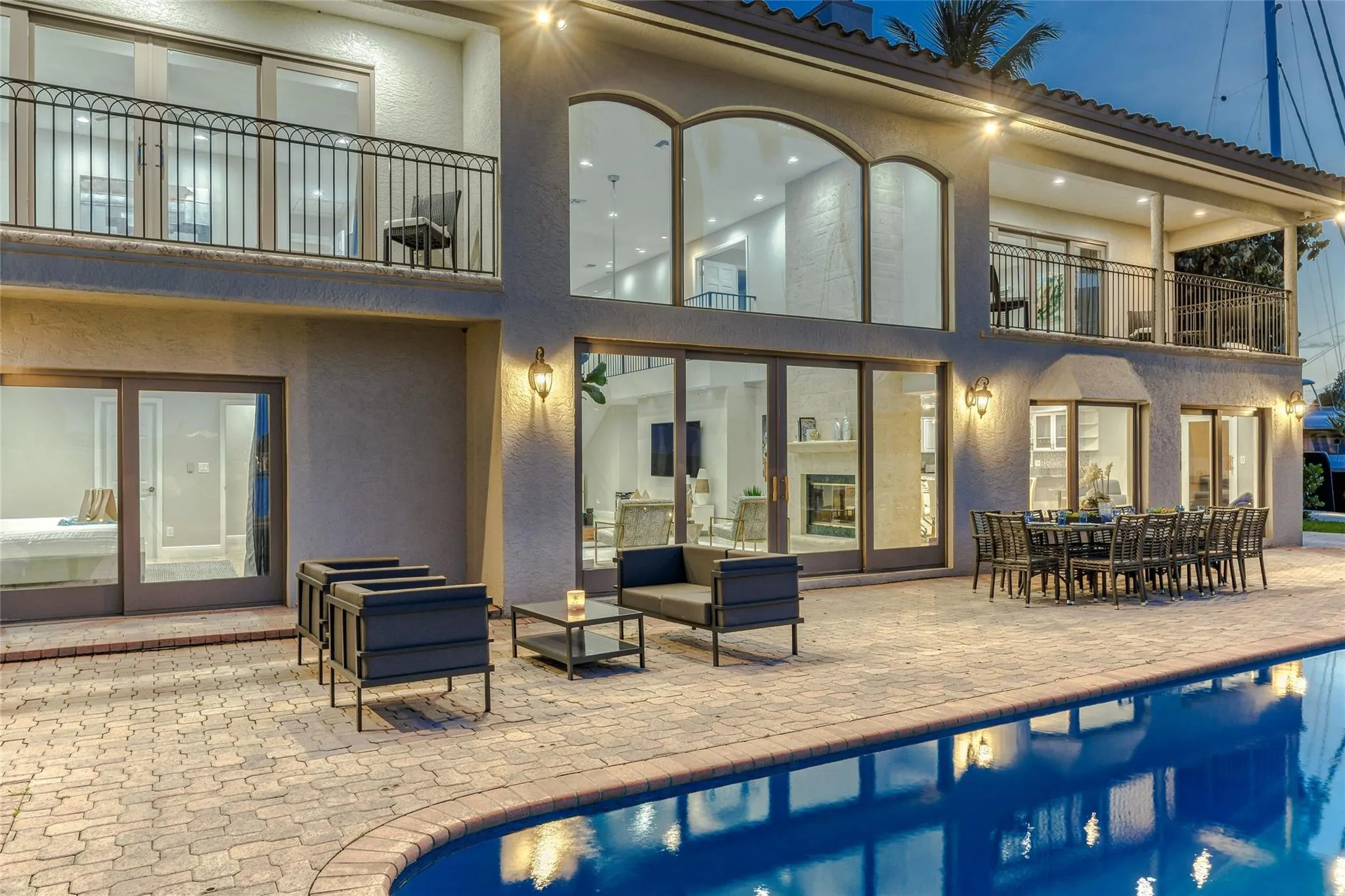 Outdoor waterfront Point Lot with pool area with outdoor dining, lounge chairs, BBQ & siting area.