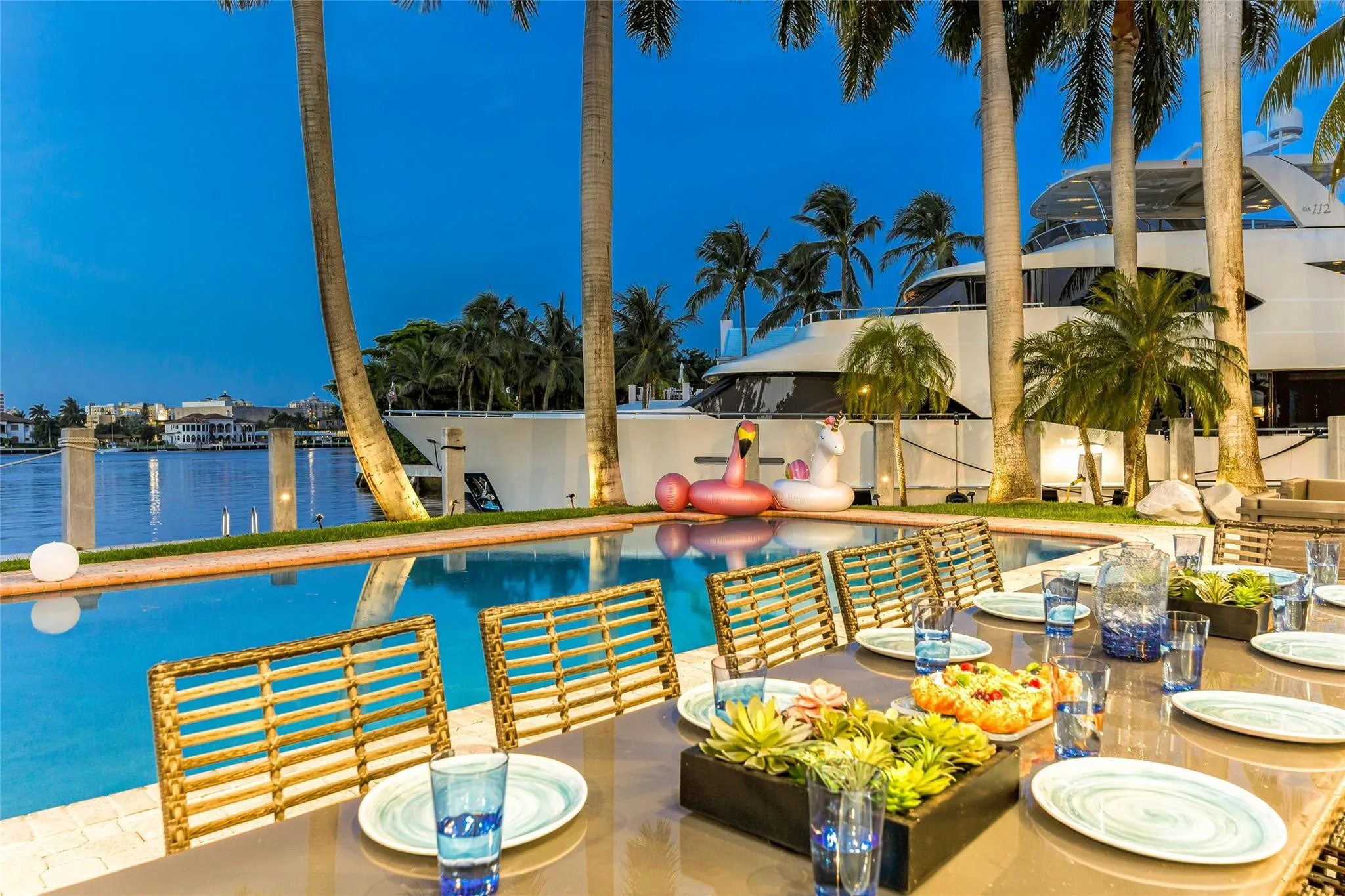Outdoor waterfront Point Lot with pool area with outdoor dining, lounge chairs, BBQ & siting area.