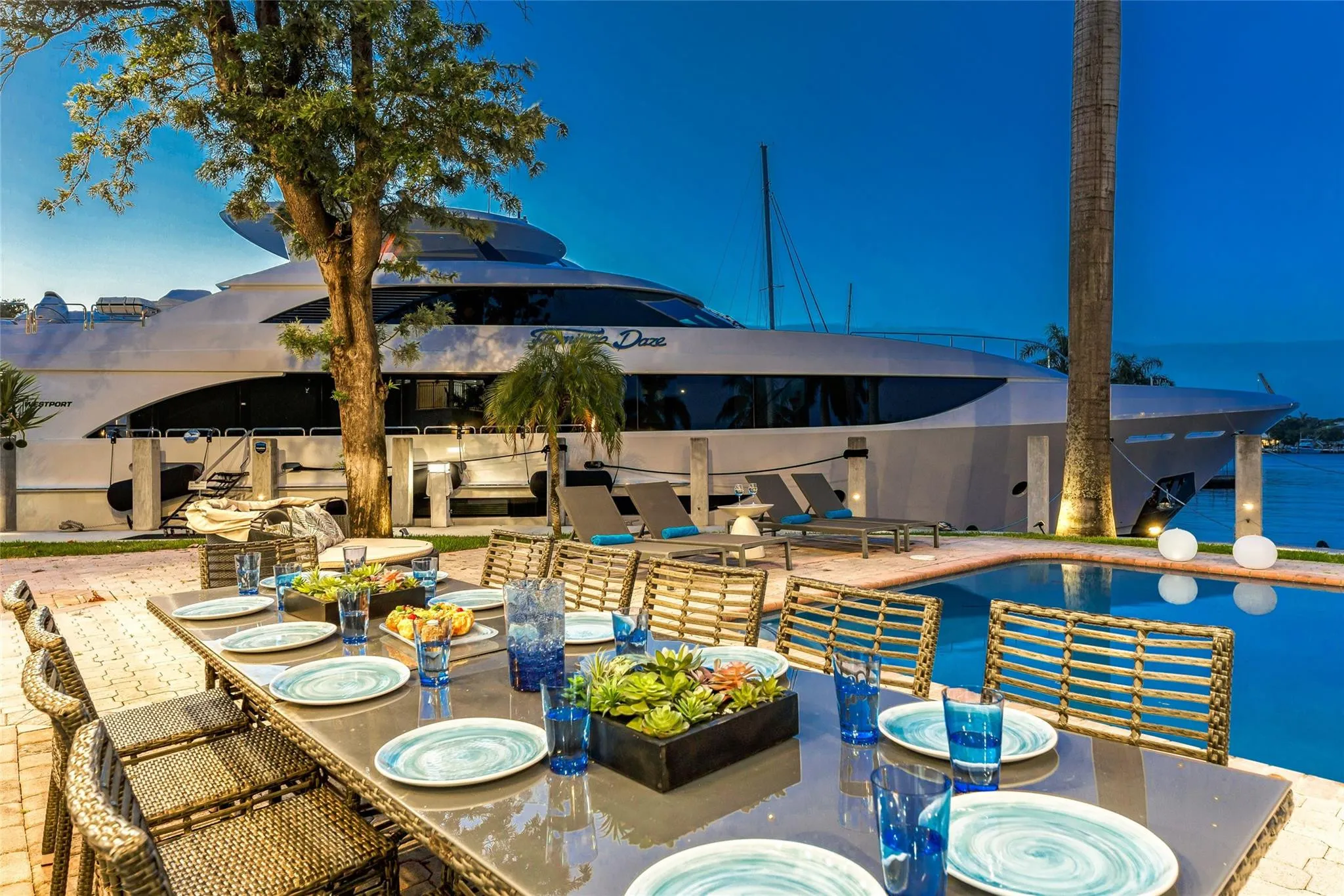 Outdoor waterfront Point Lot with pool area with outdoor dining, lounge chairs, BBQ & siting area.