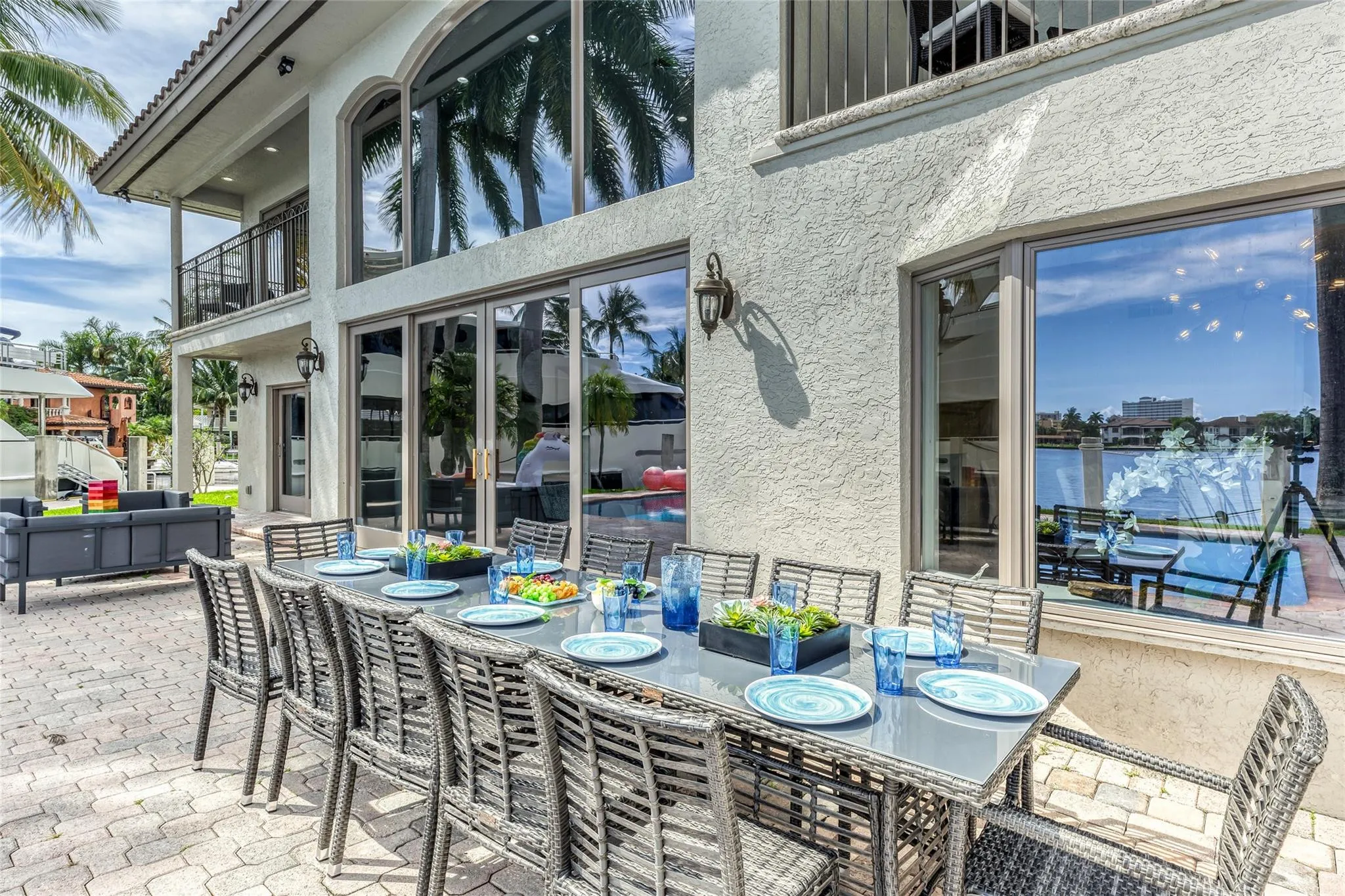 Outdoor waterfront Point Lot with pool area with outdoor dining, lounge chairs, BBQ & siting area.