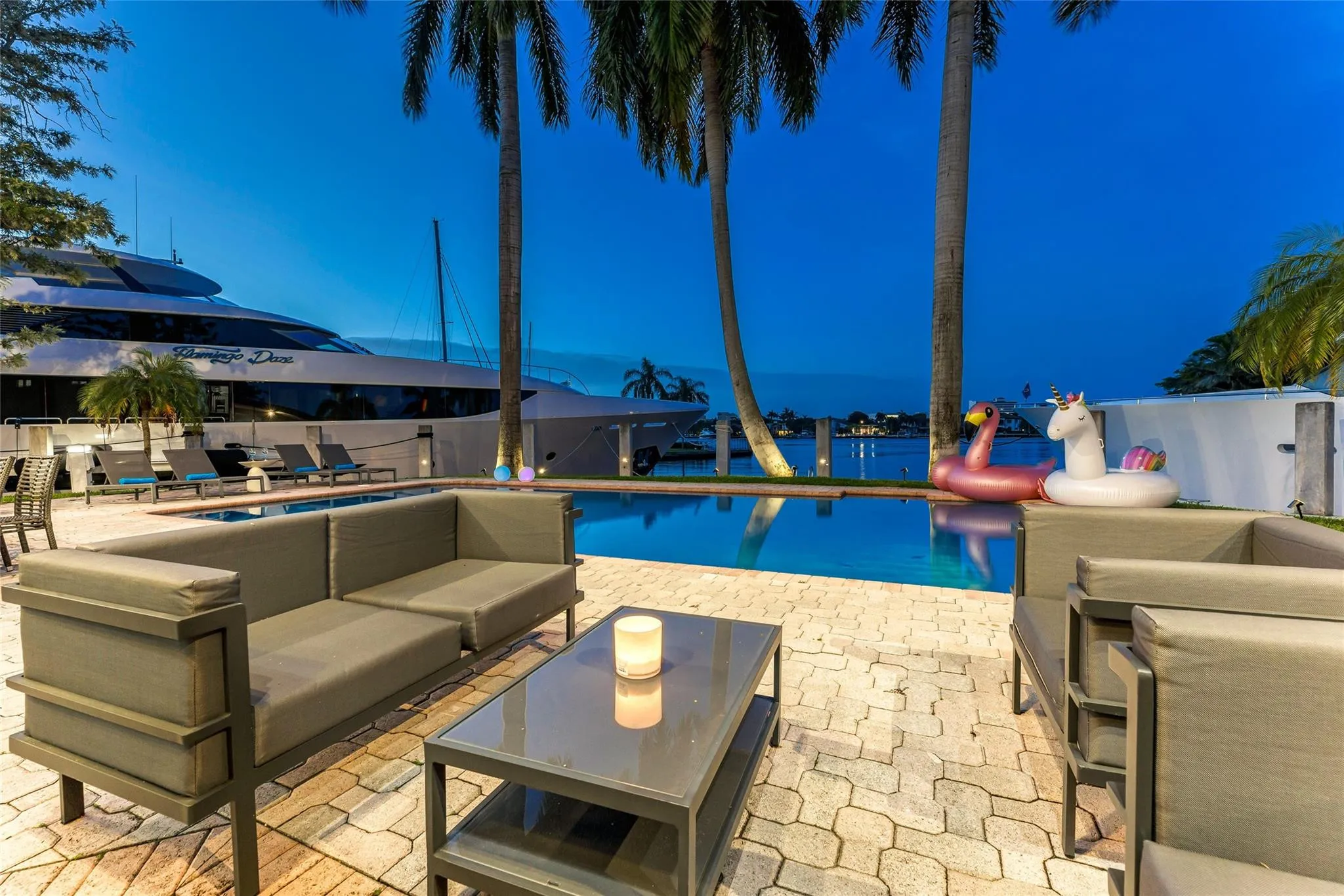 Outdoor waterfront Point Lot with pool area with outdoor dining, lounge chairs, BBQ & siting area.