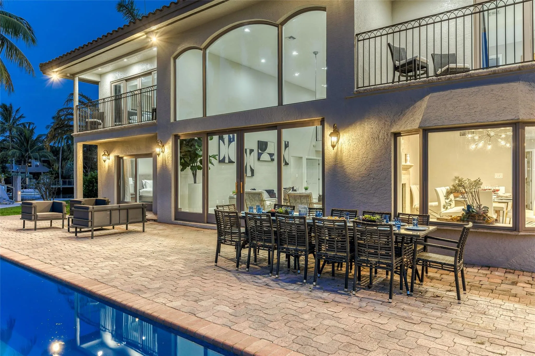 Outdoor waterfront Point Lot with pool area with outdoor dining, lounge chairs, BBQ & siting area.