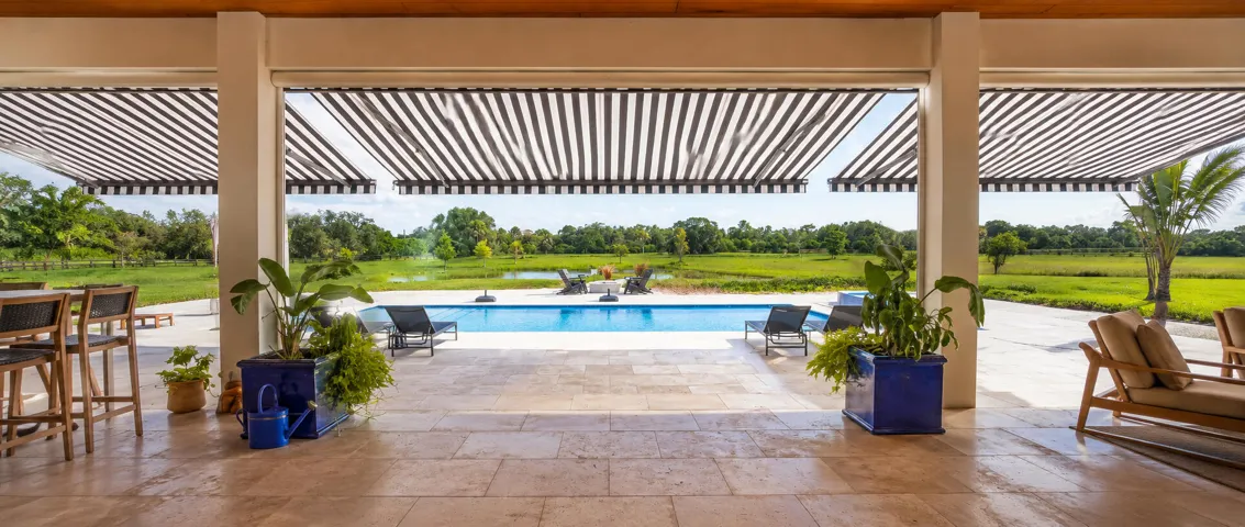 Luxurious patio with pool and greenery