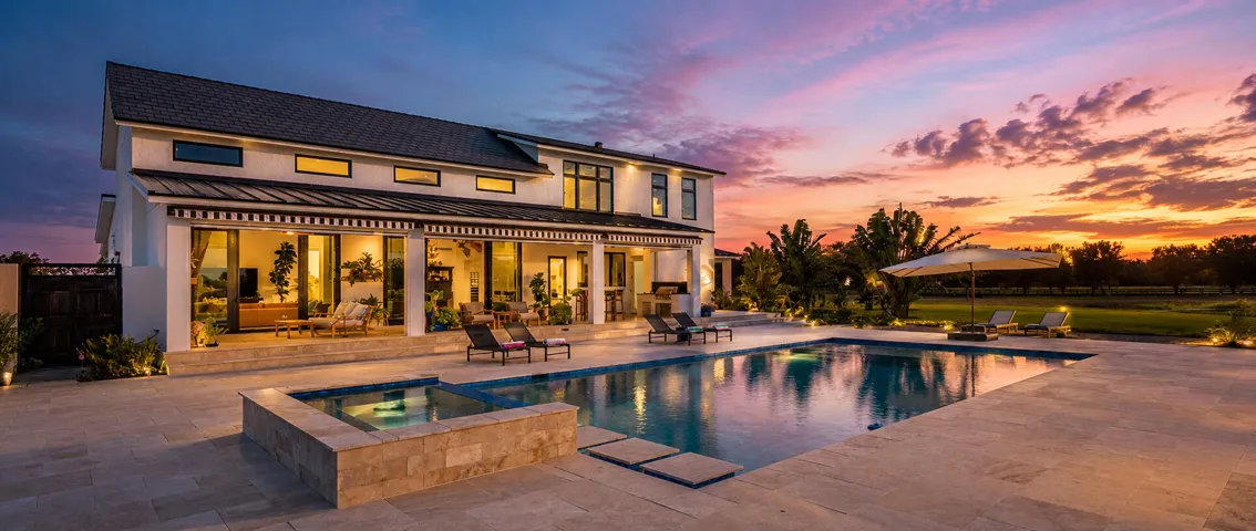 Luxury home and pool at sunset