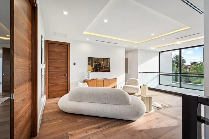 A serene modern bedroom retreat featuring clean architectural lines, a low-profile platform bed, and expansive windows framing tranquil water views. Minimalist yet warm, this private sanctuary blends contemporary design with effortless coastal elegance.
