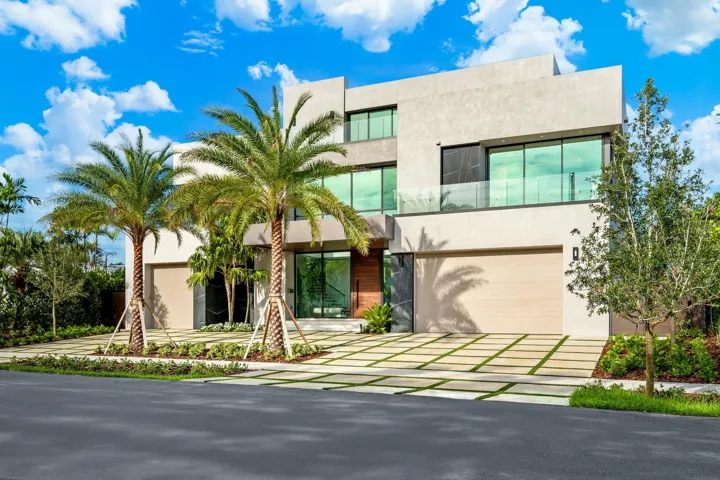 A bold contemporary exterior defined by crisp geometric lines, expansive glass, and a striking flat-roof profile framed by mature palms. Clean, modern, and architecturally impressive, this residence delivers commanding curb appeal in a refined coastal setting.