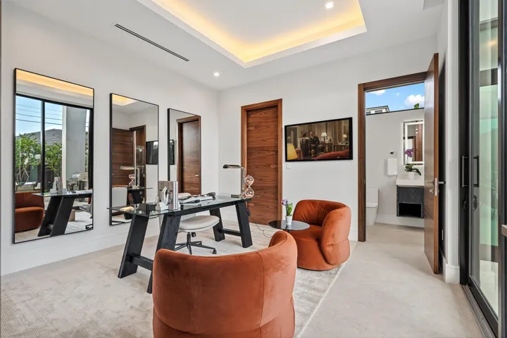 A beautifully appointed guest bedroom featuring warm contemporary finishes and direct access to a stylish cabana bath. Bright and inviting, this versatile suite offers seamless indoor-outdoor flow for ultimate comfort and convenience.
