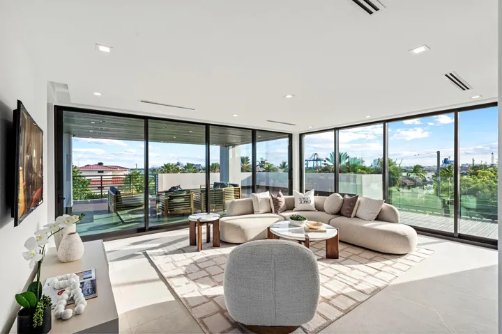 A breathtaking glass-wrapped sky lounge offering sweeping water and skyline views from nearly every angle. Bathed in natural light, this elevated retreat blends modern elegance with an unforgettable coastal panorama.