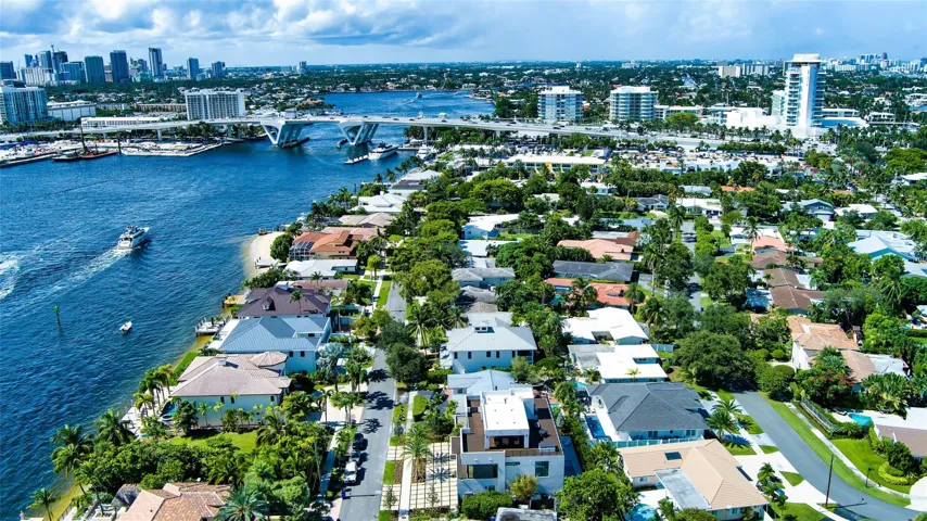 A breathtaking aerial perspective showcasing the neighborhood’s prime waterfront location along the Intracoastal, with the Fort Lauderdale skyline rising in the distance. Perfectly positioned near beaches, marinas, and Las Olas Boulevard, this setting embodies the very best of coastal luxury living.