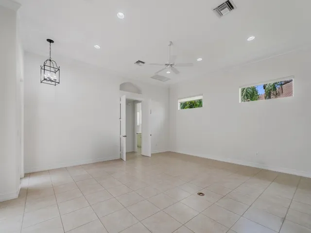 GREAT ROOM WITH TRANSOM WINDOWS AND NUMEROUS RECESSED LIGHTS