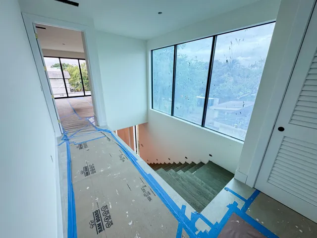 (as of April 8, 2026) the second level is seamlessly connected by the floating concrete staircase, with light pouring in from the full-height picture windows