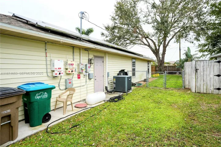 Side yard, solar panels and door to garage