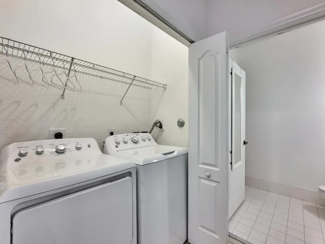 Washer and Dryer/ complete set of hurricane panels stored in this closet.