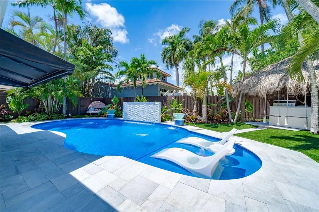 Pool chairs and water fall accent