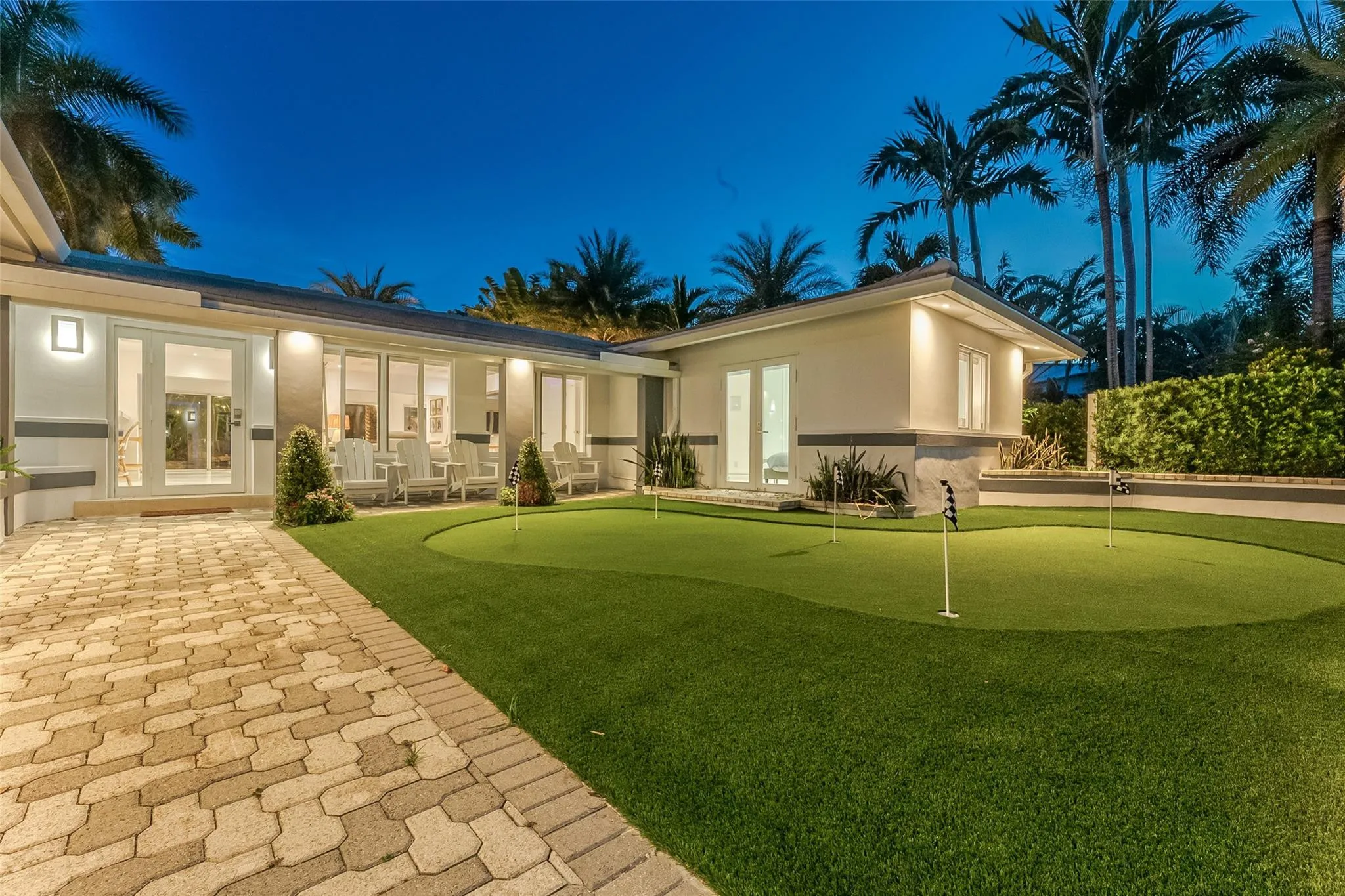 Gated entry to home with putting green.
