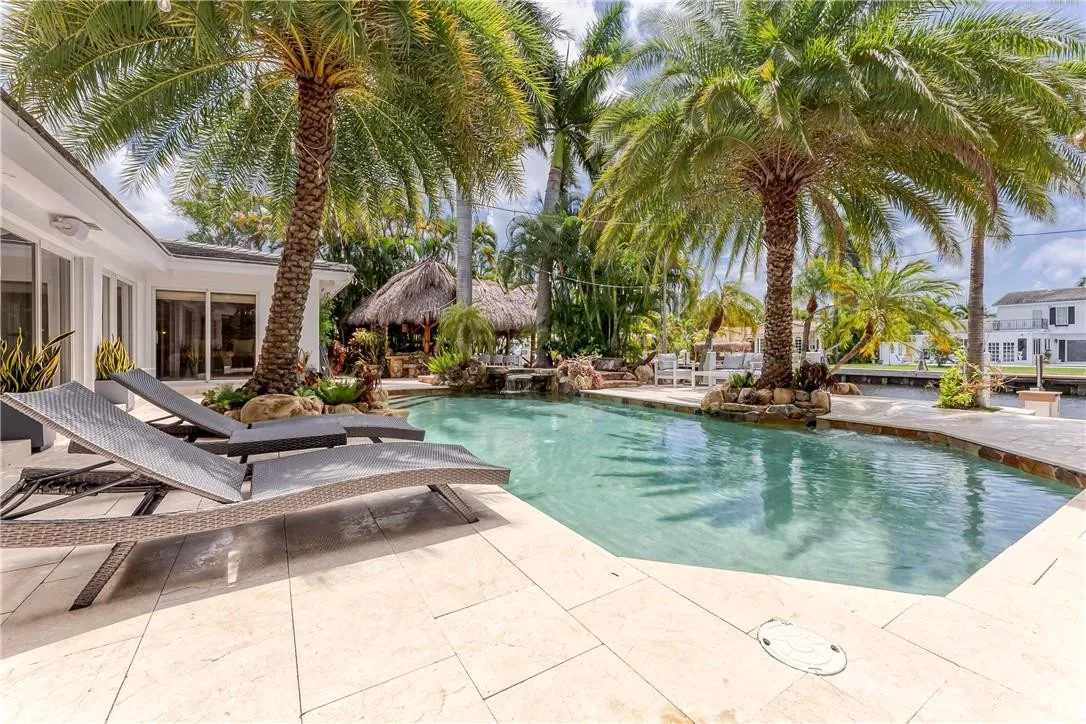 Comfy lounge chairs and large palm trees for shade