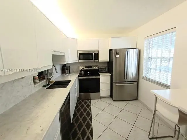 Sleek with new appliances and eat in kitchen