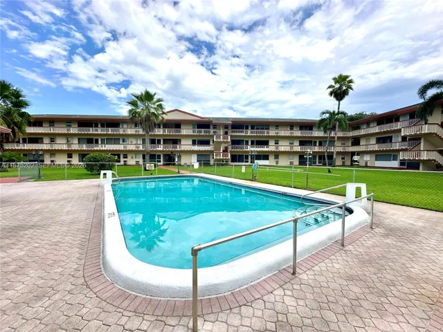 Enclosed patio at the entrance of the unit with a view of the pool area