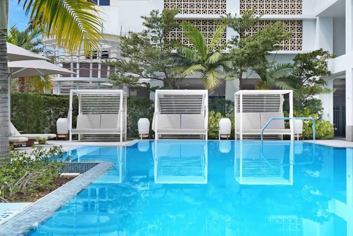 Resort-style pool surrounded by cabanas