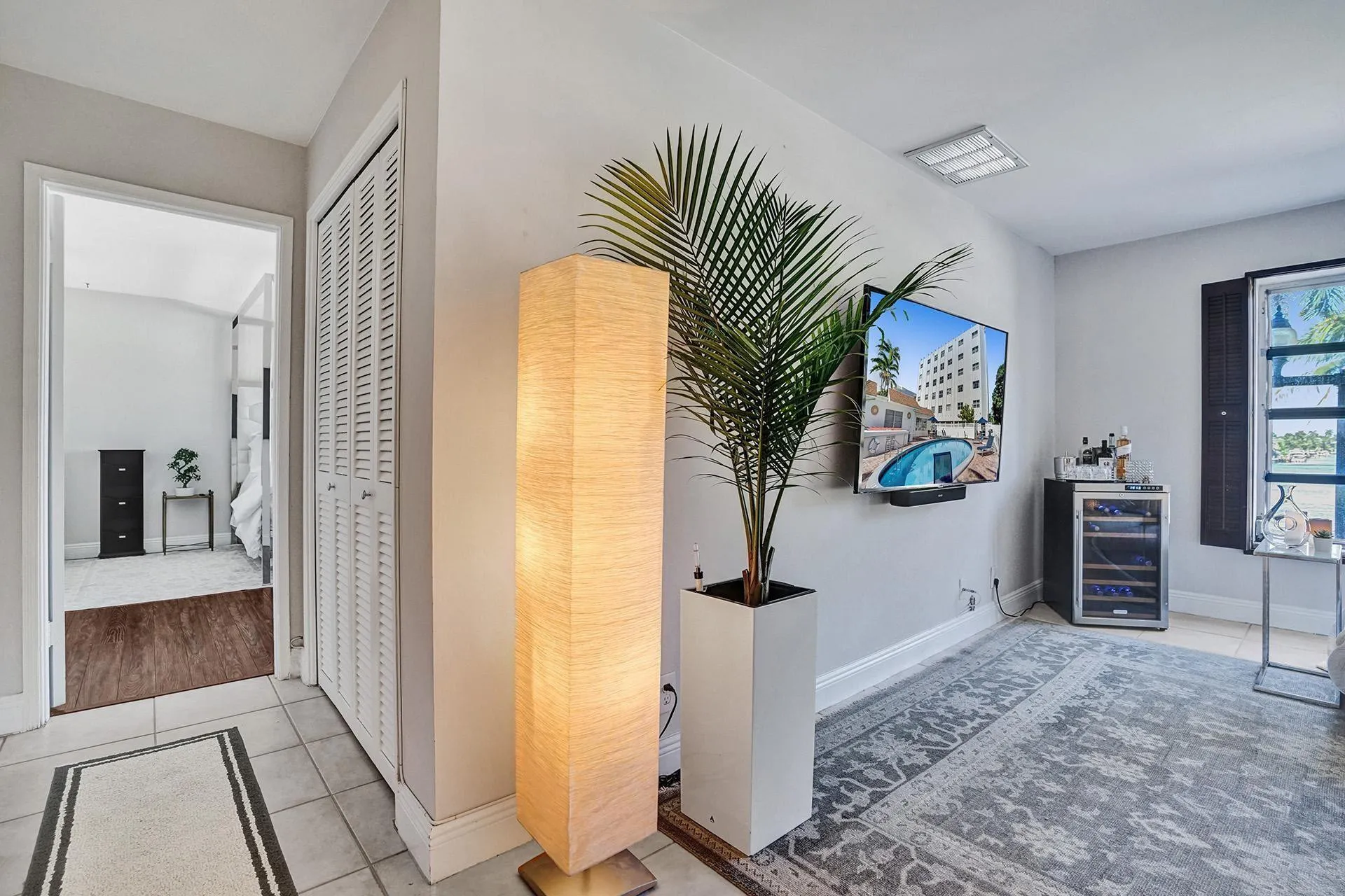 SMALL HALLWAY LEADS TO LARGE BEDROOM.