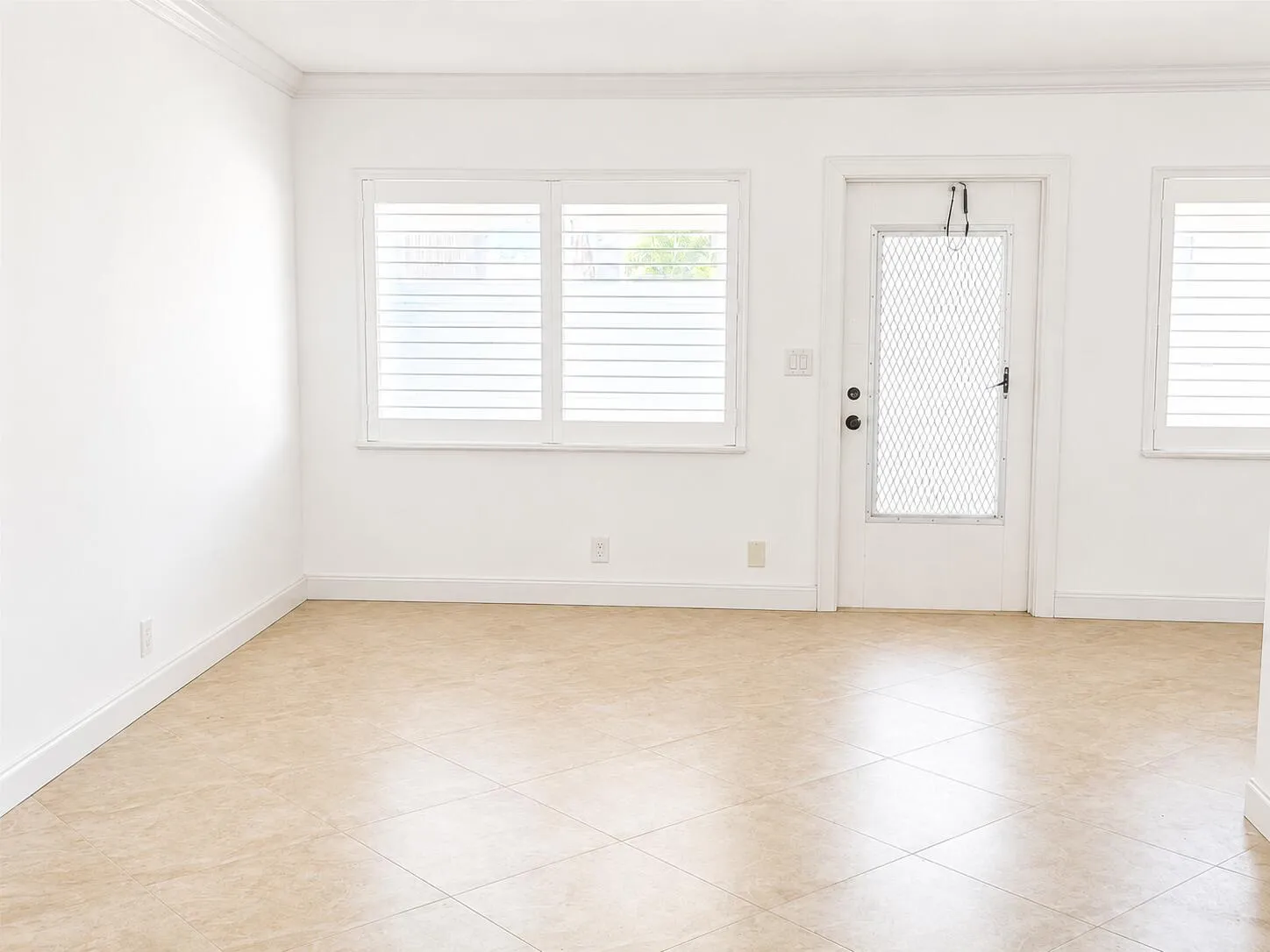 tile floors, plantation shutters in this living area