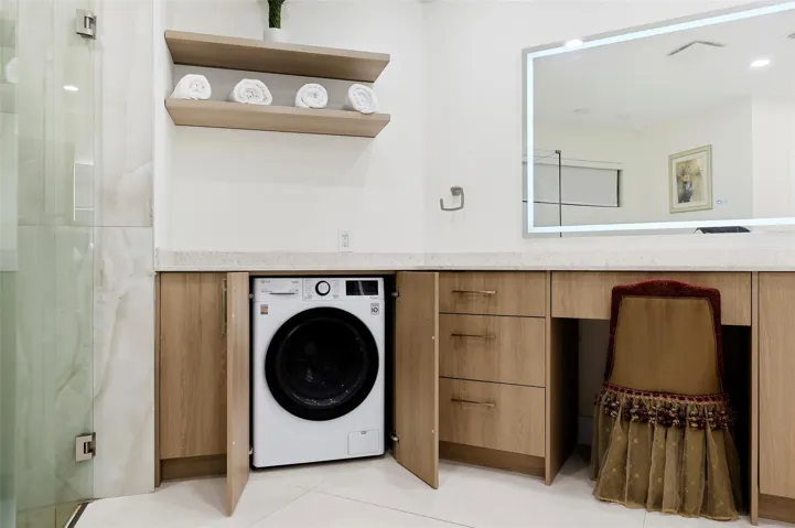 Dual washer and dryer in bathroom.