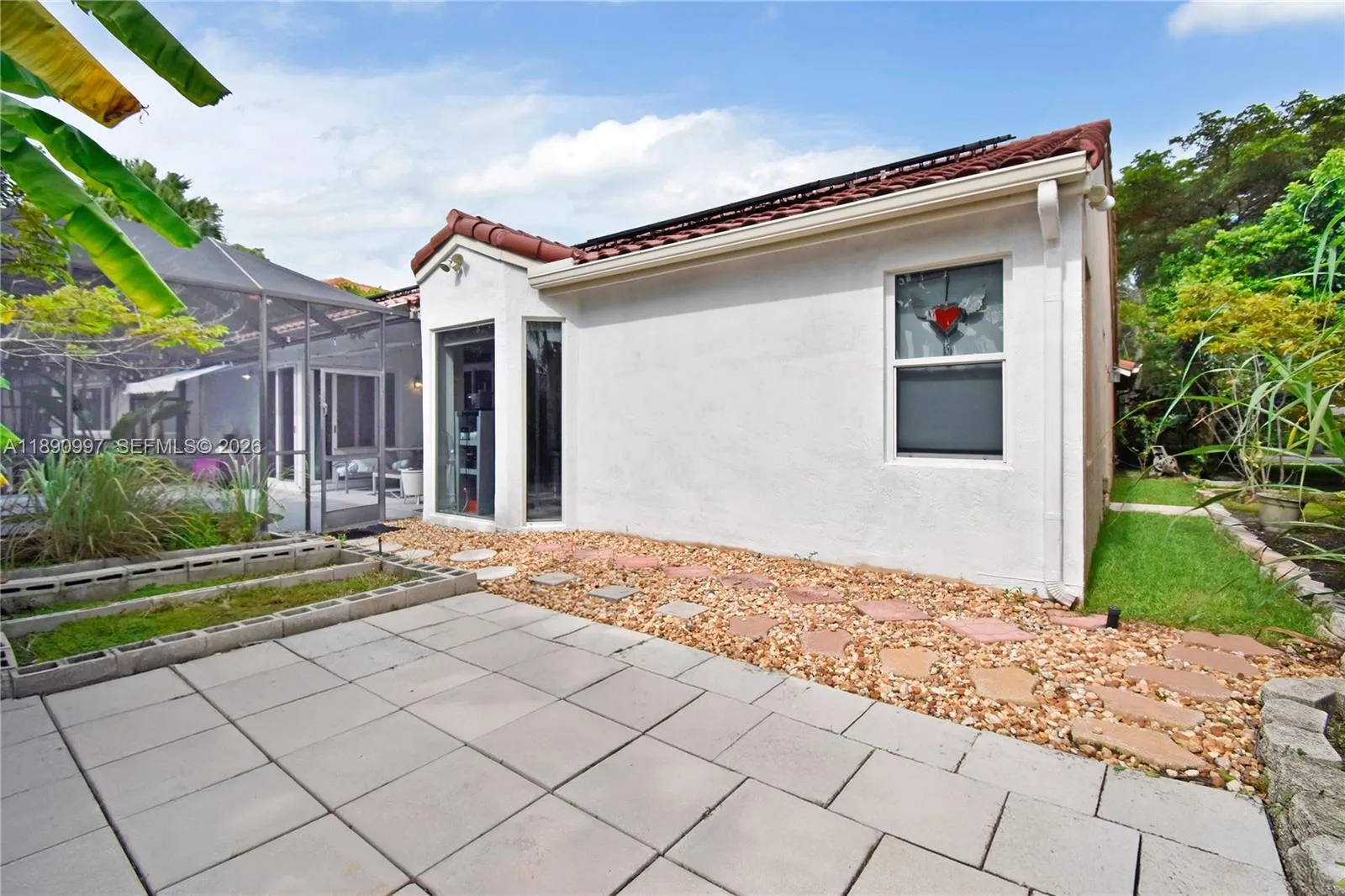 Screened patio adjacent to open patio, offering the opportunity to create one expansive outdoor living space